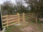 Wooden wicket gate with post and rail fencing